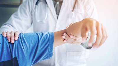 Doctor examining patient's arm