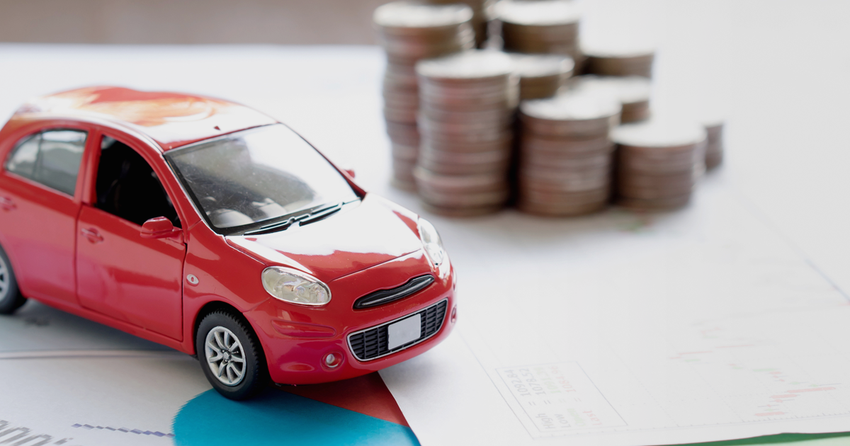 Red toy car and coins 