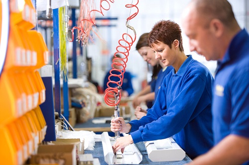 Workers on a manual assembly line