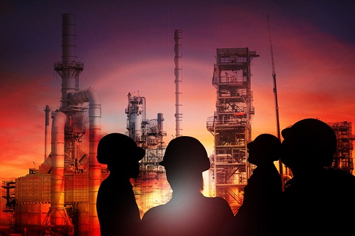 Wokers in hard hats at a refinery