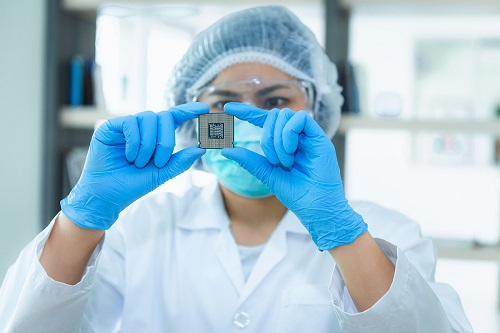 Clean room worker holding a microchip
